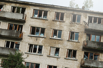 Exterior of abandoned apartment building in european ghost town.
