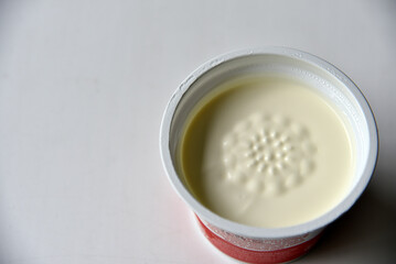 Fototapeta na wymiar Jar with white sour cream on a white background