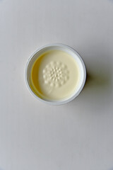 Jar with white sour cream on a white background