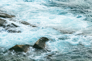 Waves crashing on a rocky coast during a high tide.