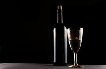 bottle of wine and glasses on a black background