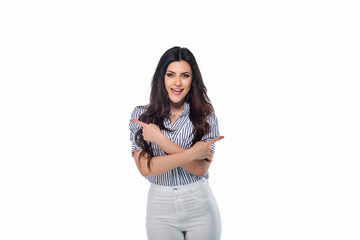 Beautiful smiling happy brunnet сaucasian young girl in white pants and striped shirt pointing right and left with her fingers isolated on white background