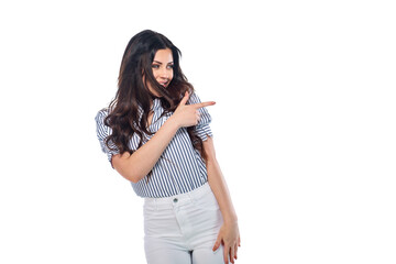 Beautiful smiling happy brunnet сaucasian young girl in white pants and striped shirt pointing right with her finger isolated on white background