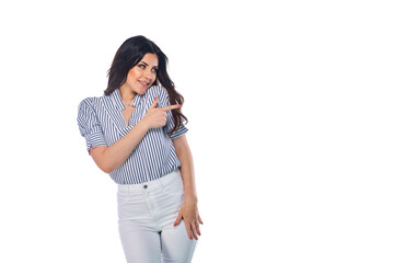 Beautiful smiling happy brunnet сaucasian young girl in white pants and striped shirt pointing right with her finger isolated on white background