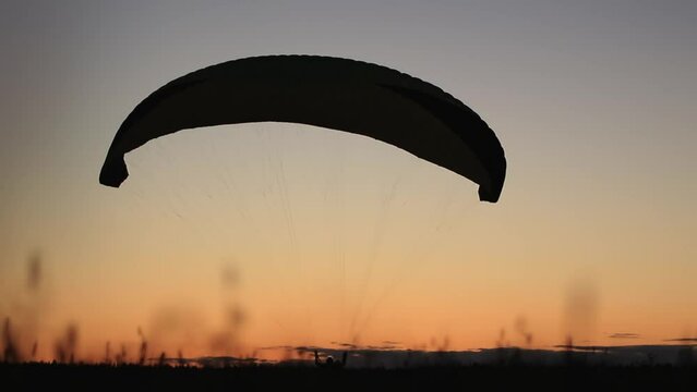 paragliding takeoff at sunset