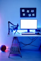 Fotobehang Gaming Vertical background image of gaming room with blue neon lighting and PC white screen mockup  © Seventyfour