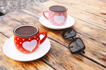 Obraz premium Two cappucinos sitting on a wooden counter in coffee shop