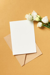 Invitation or greeting card mockup with envelope and white eustoma flowers