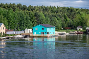 landscape with a view from the river boat to the coastline on a summer day