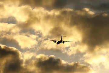 Airplane in the cloudy sky.