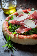 Fresh pizza Parma with parma ham and parmesan cheese.