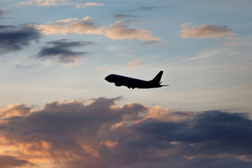 Fototapeta na wymiar Airplane in the cloudy sky.