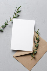 Wedding invitation card mockup with envelope and natural eucalyptus twigs © nikavera