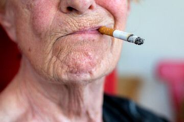close-up of an old woman smoking a cigarette