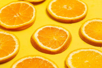 Sliced orange set on yellow background