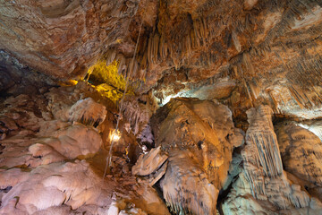 Natural stalactite and stalagmite rock stone cliff hang from cave ceiling in cave. Environmental explore. Landscape background. Erosion