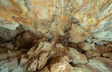 Natural stalactite and stalagmite rock stone cliff hang from cave ceiling in cave. Environmental explore. Landscape background. Erosion