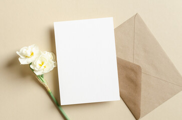 Blank greeting card mockup with envelope and daffodils flowers