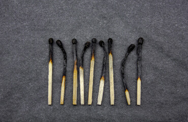 Burnt matches on a dark background. Burnt wooden matches.