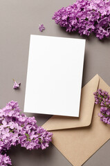 Invitation or greeting card mockup with envelope and spring lilac flowers