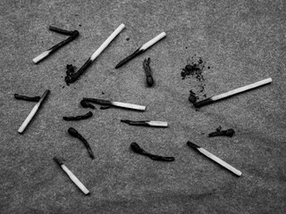 Burnt matches on a dark background. Burnt wooden matches.
