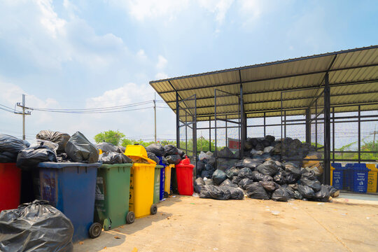 Stack of different types of large garbage pile, plastic bags, and trash in industrial factory in environmental pollution. Waste disposal in dumping site in urban city.