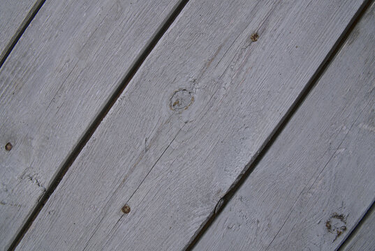 background old gray wood with shabby paint, with gaps between boards, knots. Weathered and faded natural wood with lines of boards, with space for text
