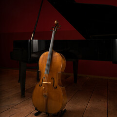 Two classical instruments - the cello and the grand piano - on a stage waiting for their musicians before a recital