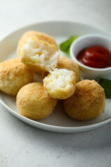 Traditional homemade arancini balls with tomato sauce