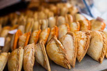 freshly baked empanadas with different fillings for sale