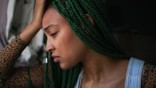 One anxious young woman suffering alone. A millennial black girl having mental distress