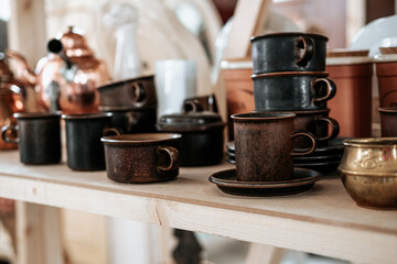 The old metal mugs on the shelf.