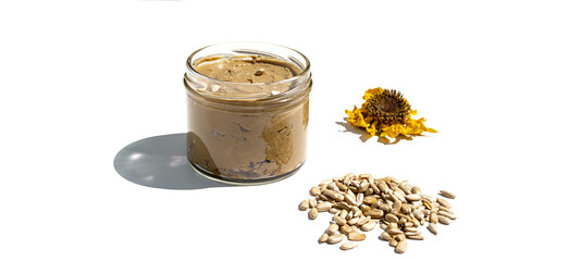 Jar of sunbutter and sunflower seed on white. Homemade sunflower seed spread, superfood organic product. Modern wellness and vegan concept.