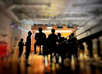Behind the scenes of music video shooting production crew team silhouette and camera equipment in studio. 