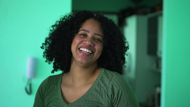 One young African American woman smiling portrait looking at camera