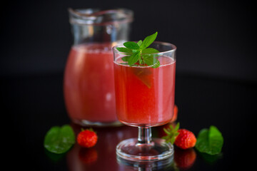 Cold summer strawberry kvass with mint in a glass