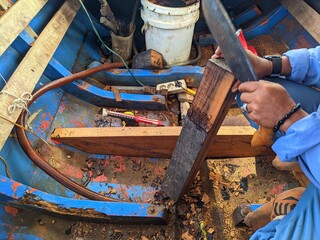 worker cutting ironwood