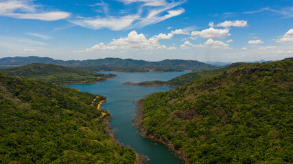 Fototapeta na wymiar Tropical mountain range and blue lake. Kalu Ganga Reservoir, Sri Lanka.