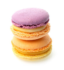 Violet orange and orange yellow macarons with yellow filling on isolated white background one on the other