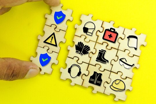 wooden puzzle with Security priority icon. the concept of safety in industry