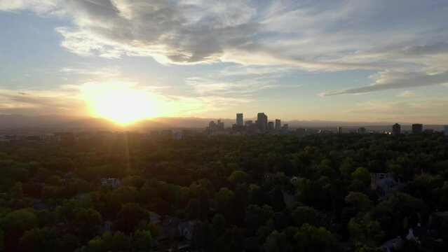 Downtown Denver Colorado Aerial establishing rising jib shot at sunset with mountains in view