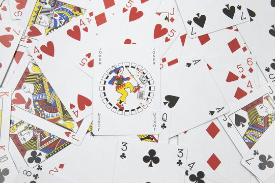 Joker card over playing Cards for poker background