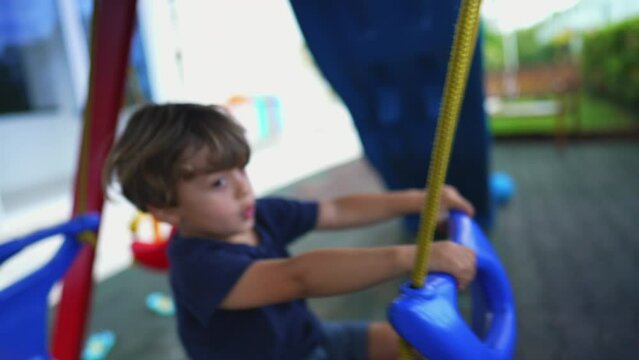 Child plays at playground car swing