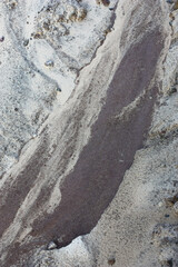 Small fragment of the dirt road after a rain. The abstract picture was created by the flowing-down water.