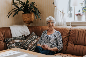 Senior woman sitting on sofa