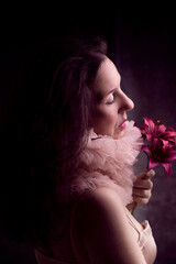 portrait of beautiful woman smelling a bouquet of lilies IV