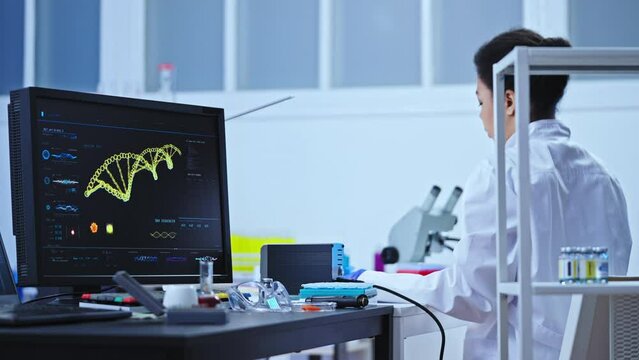 Genetic laboratory scientist working on research dna sequence on computer screen