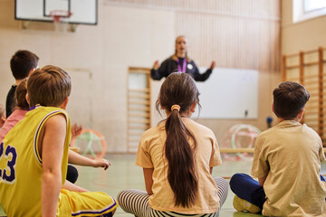 Children having class in school gym