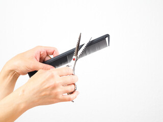 Professional hairdressing instrument in hand on the white background.
