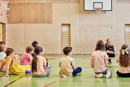 Children having class in school gym